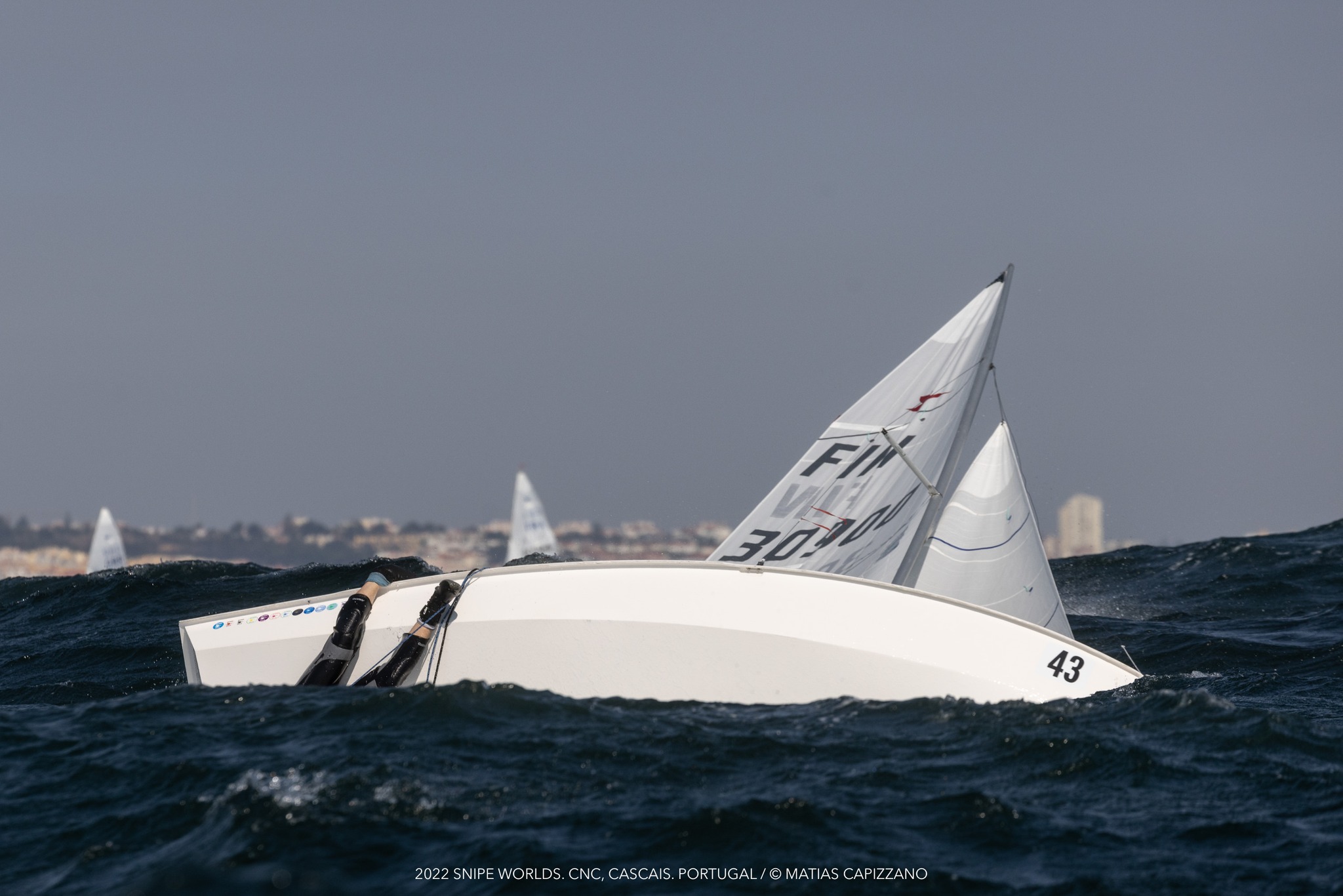 Helping a Capsized Boat in a Race Image